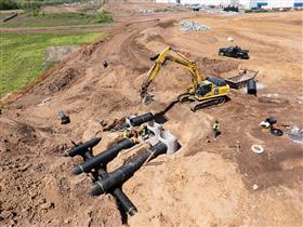 Landis C. Deck & Sons Division: A pipe crew works on setting sections of pipe for a basin.